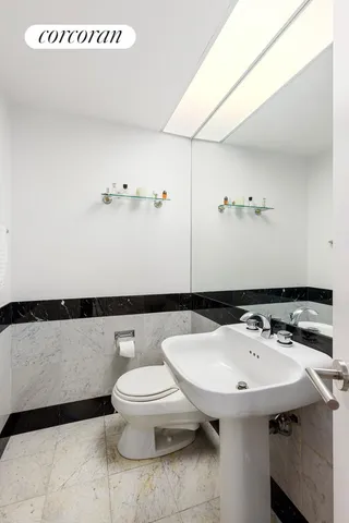 a bathroom with a granite countertop sink mirror toilet and bathtub