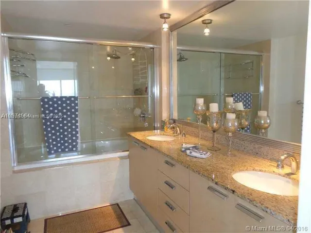 a bathroom with a glass door shower