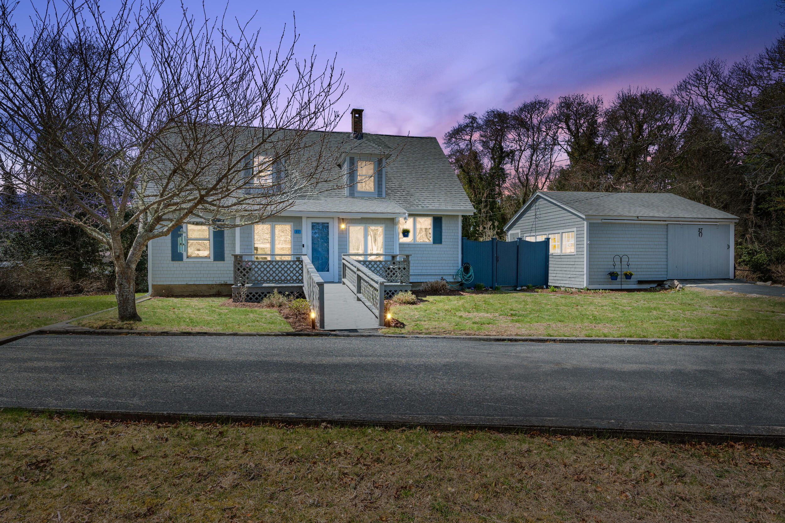 a front view of a house with a yard and a garage