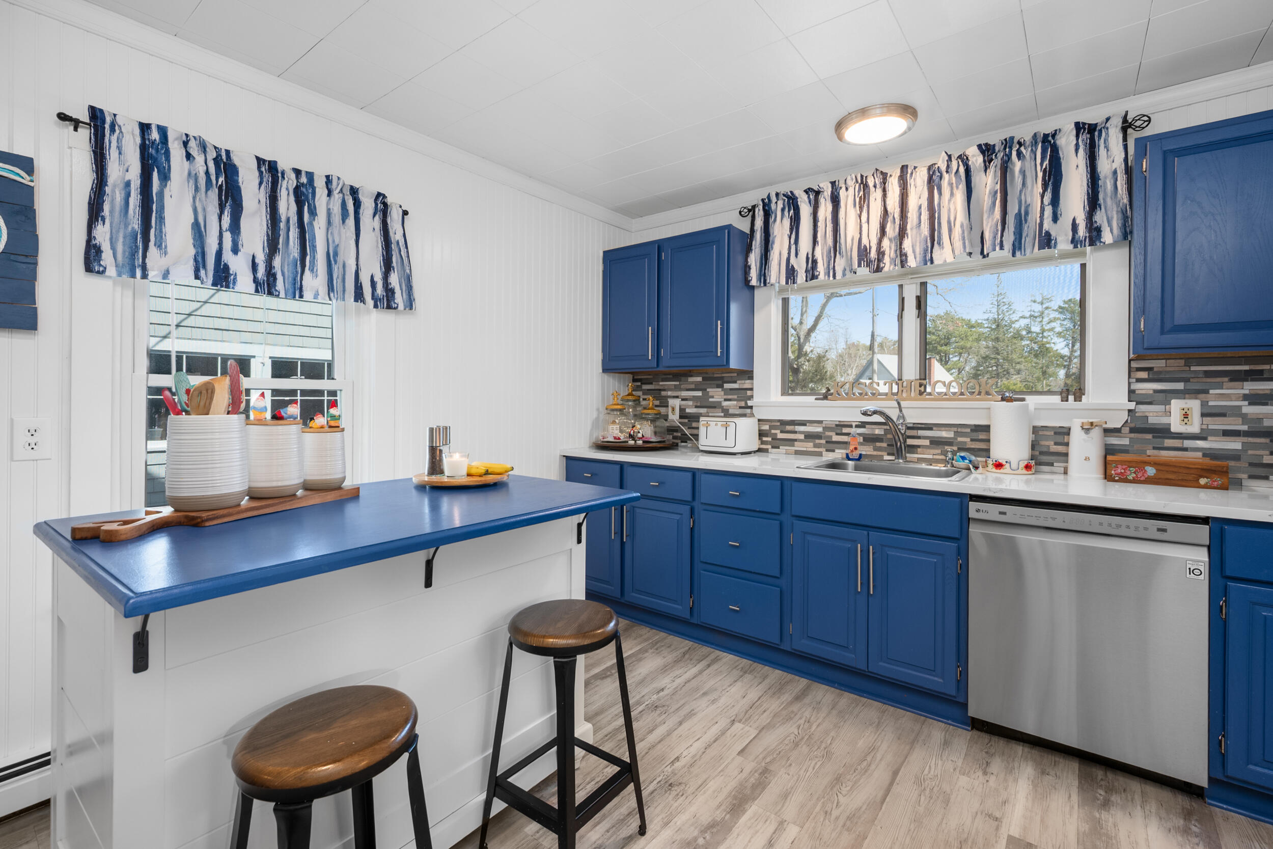 27 Head Of The Bay Road Buzzards Bay, MA 02532 - Photo 11 of 43 a kitchen with stainless steel appliances granite countertop a sink table and chairs