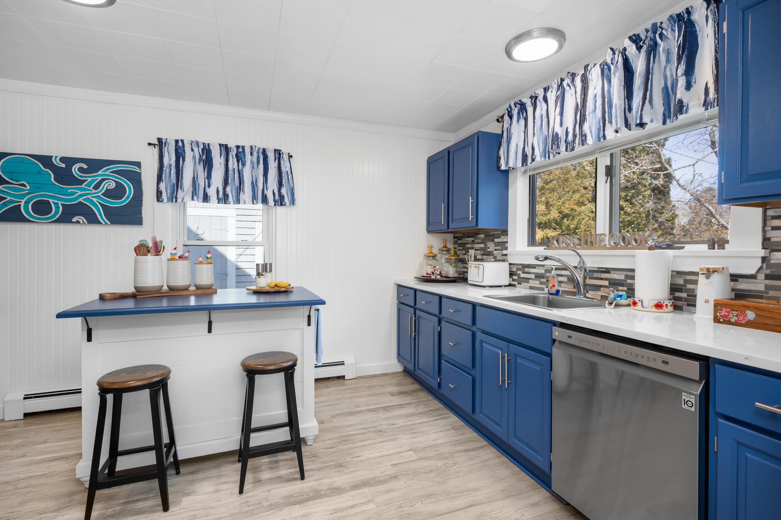 27 Head Of The Bay Road Buzzards Bay, MA 02532 - Photo 12 of 43 a kitchen with stainless steel appliances granite countertop a sink wooden cabinets and counter space