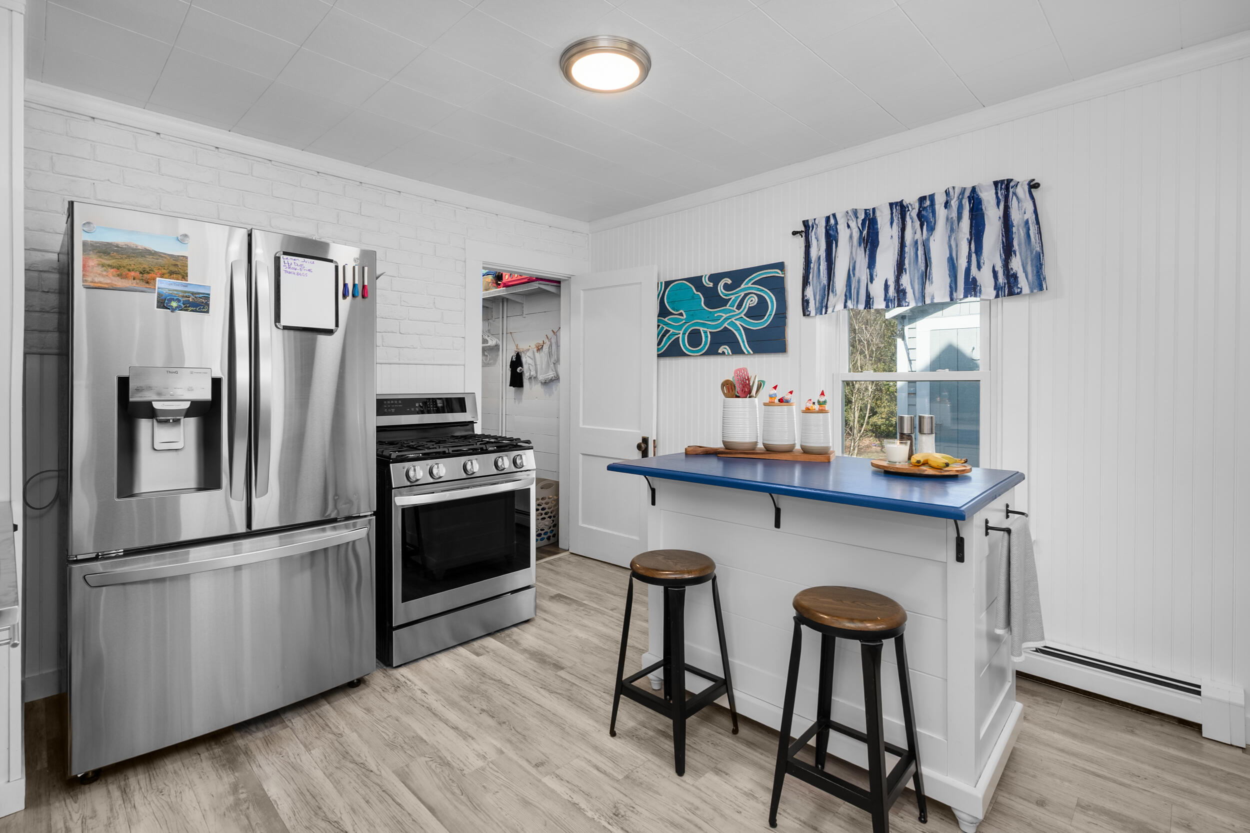 27 Head Of The Bay Road Buzzards Bay, MA 02532 - Photo 14 of 43 a kitchen with stainless steel appliances a refrigerator a stove a sink and a refrigerator with wooden floor