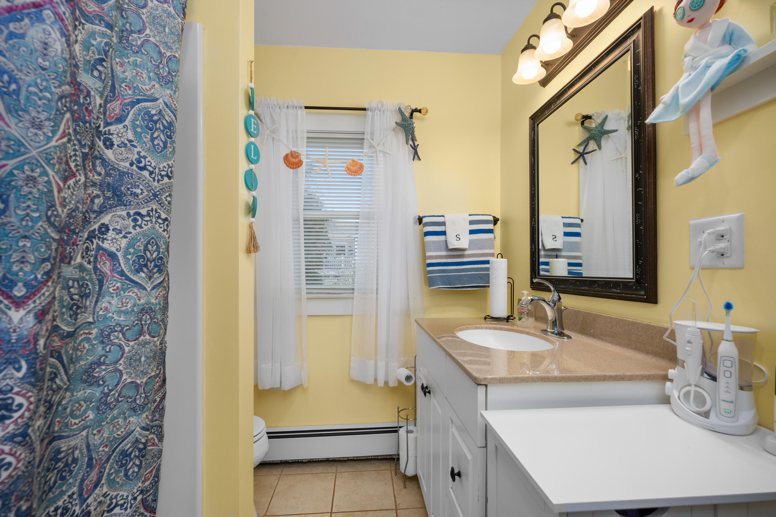 27 Head Of The Bay Road Buzzards Bay, MA 02532 - Photo 18 of 43 a bathroom with a sink and a mirror