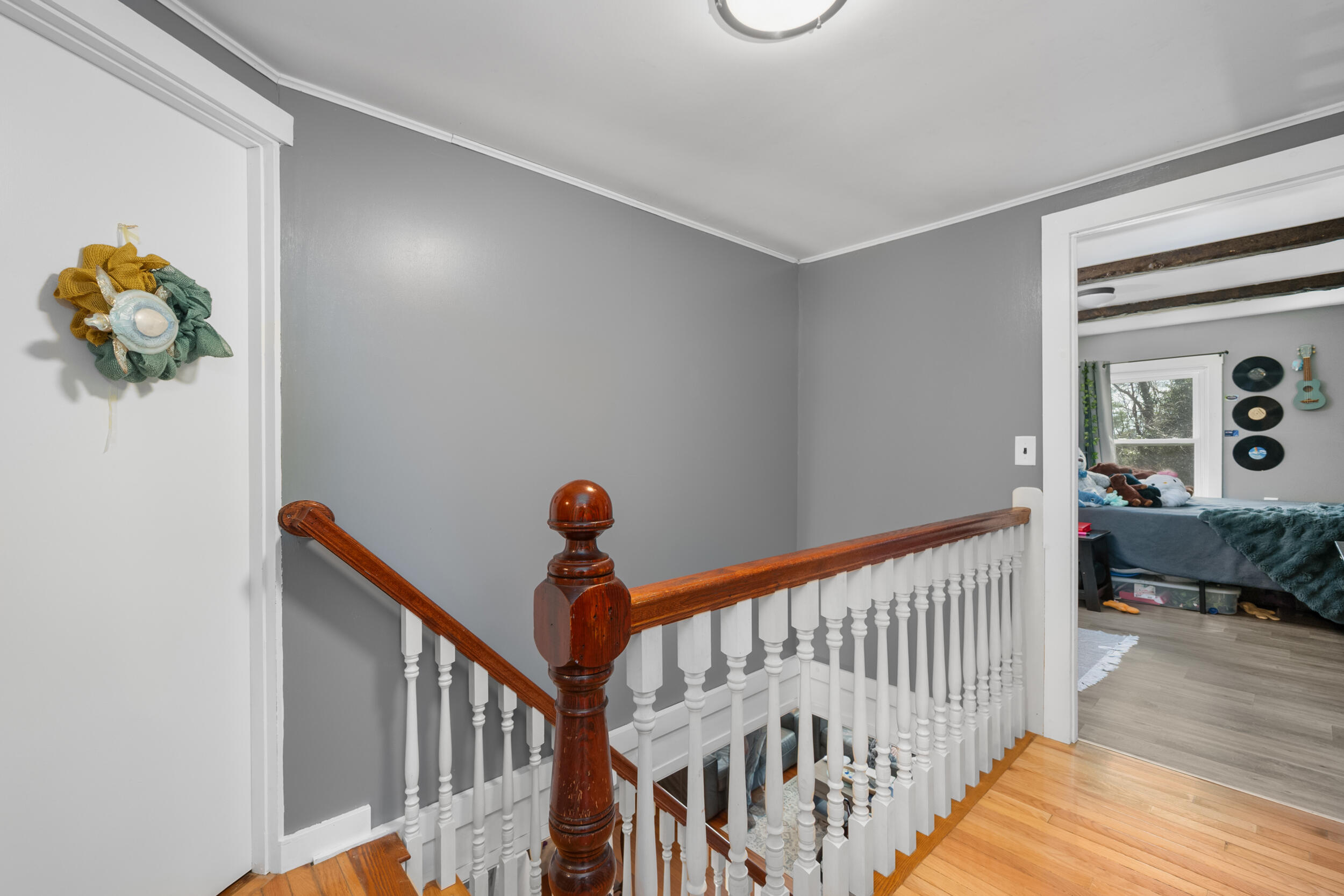 27 Head Of The Bay Road Buzzards Bay, MA 02532 - Photo 25 of 43 a view of a hallway to a livingroom with wooden floor and stairs