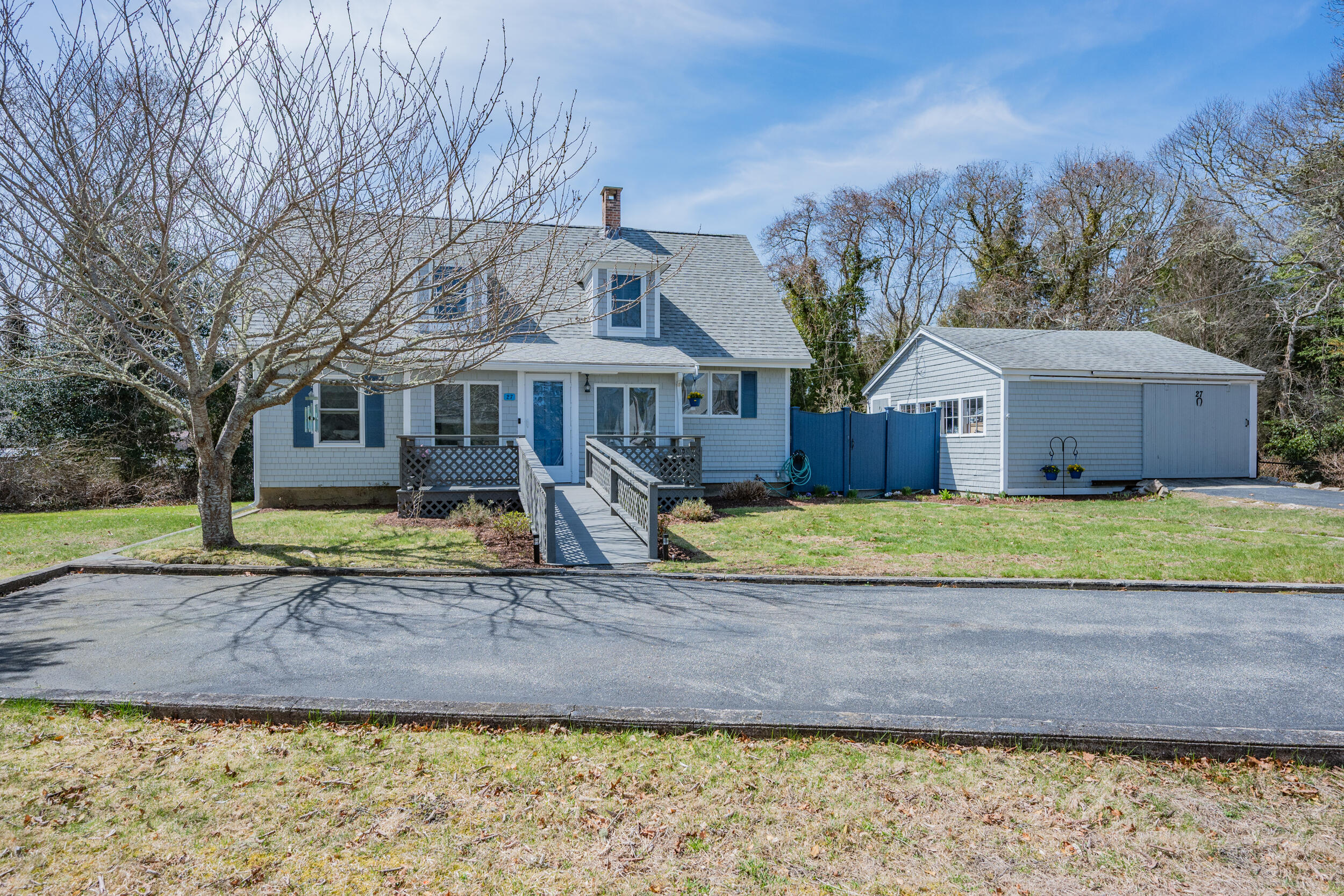 27 Head Of The Bay Road Buzzards Bay, MA 02532 - Photo 38 of 43 a front view of a house with a yard and garage