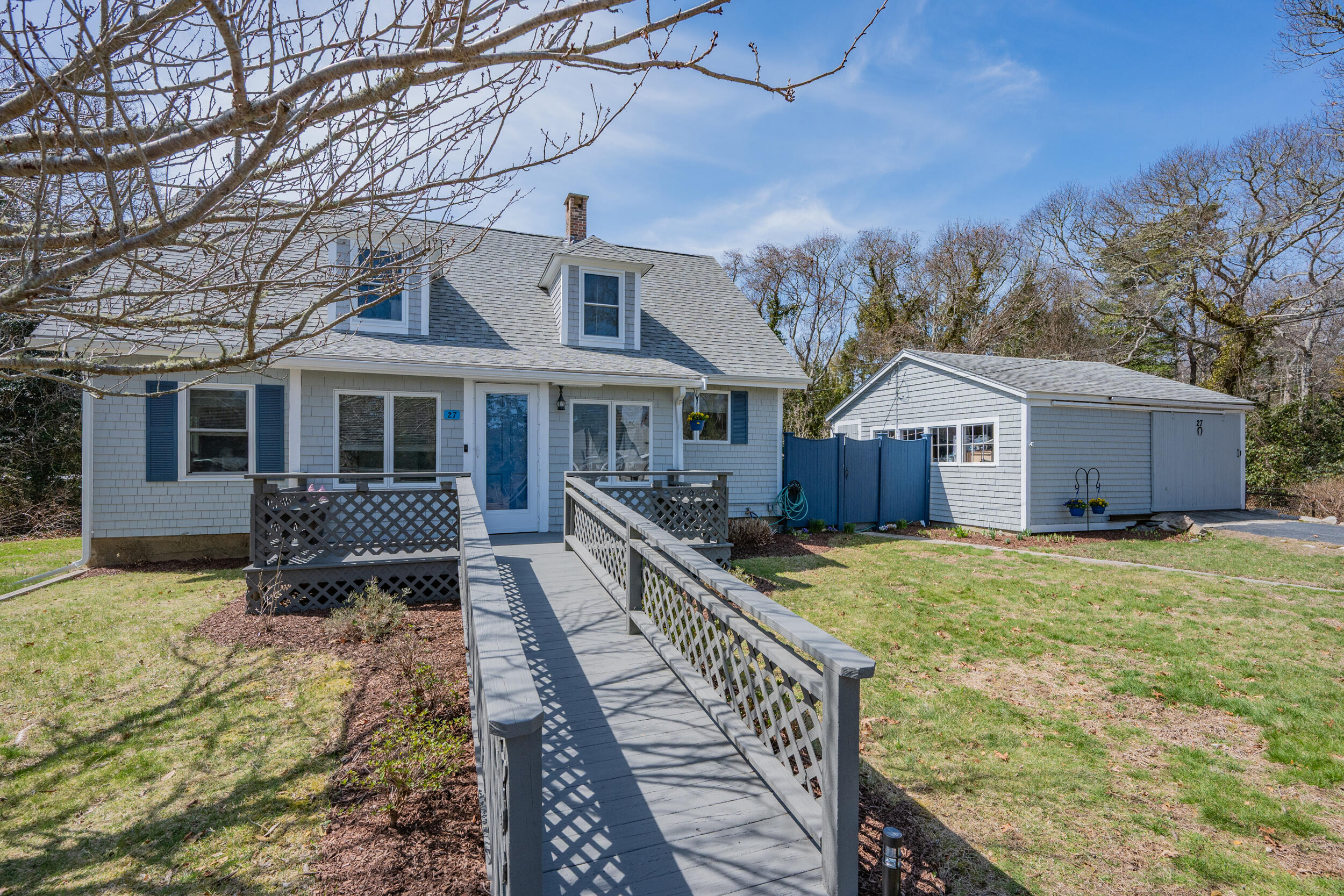 27 Head Of The Bay Road Buzzards Bay, MA 02532 - Photo 5 of 43 a front view of house with yard outdoor seating and covered with trees