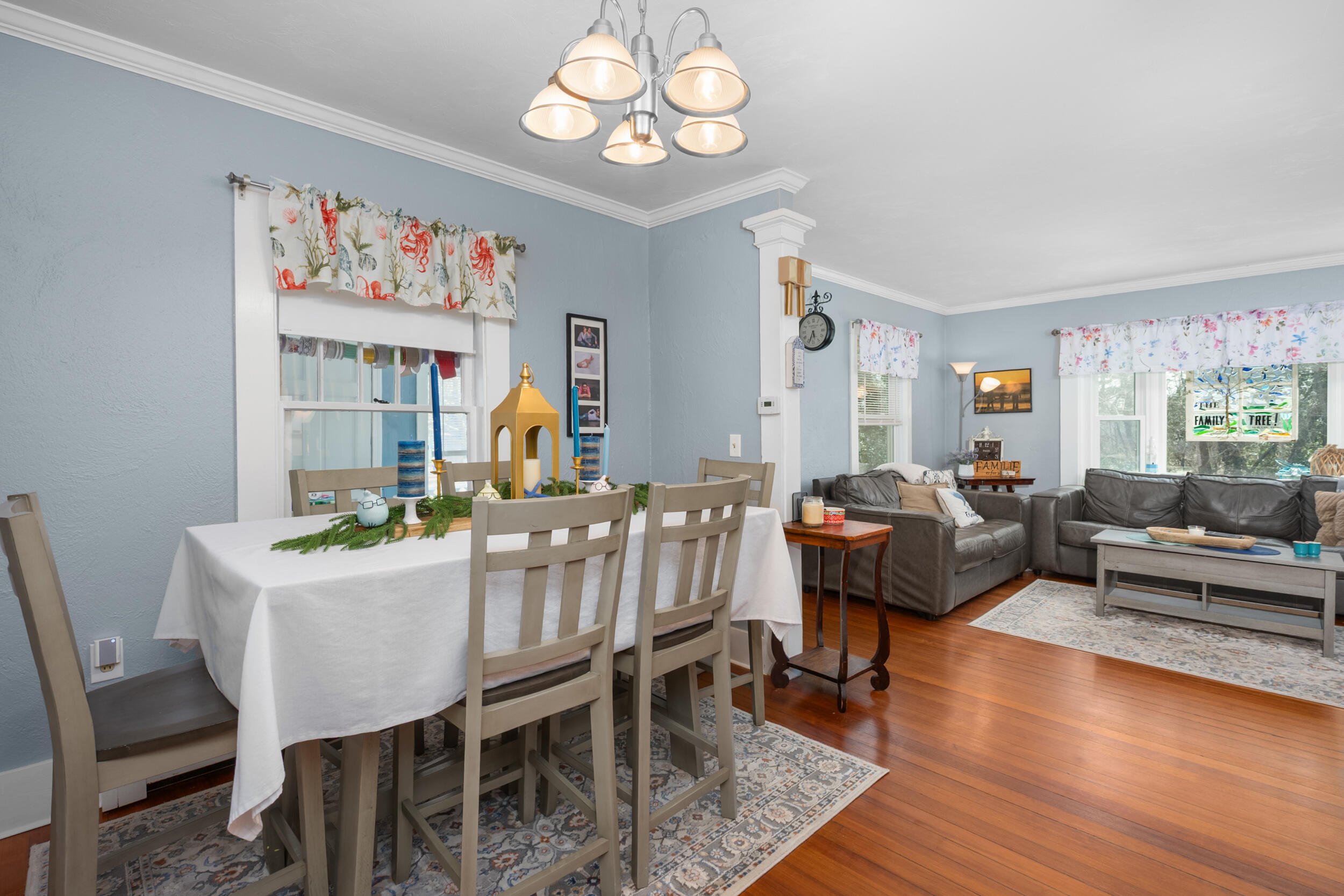 27 Head Of The Bay Road Buzzards Bay, MA 02532 - Photo 9 of 43 a dining room with wooden floor a chandelier a wooden table and chairs