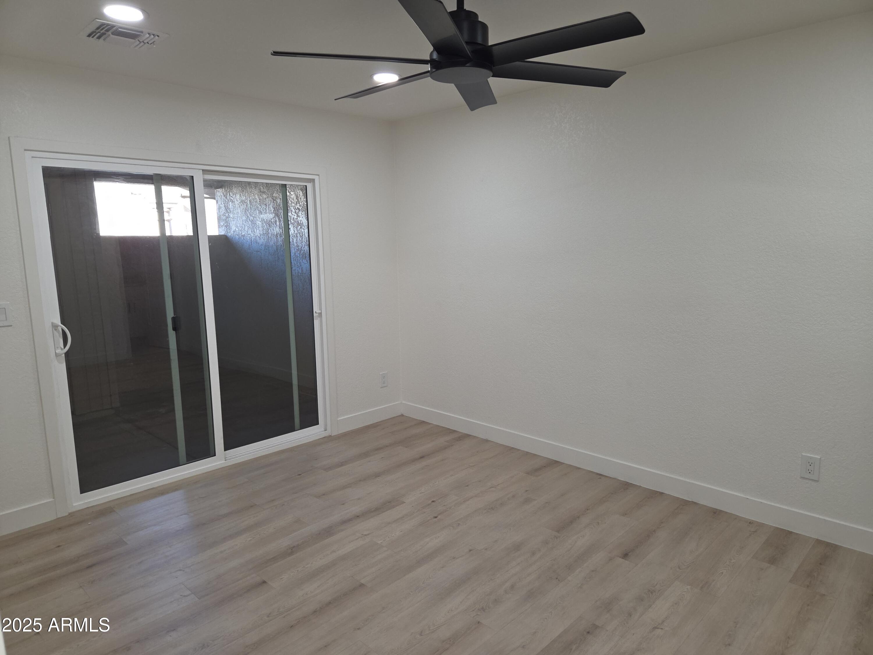 95 North Cooper Road, Unit 66 Chandler, AZ 85225 - Photo 13 of 25 wooden floor in an empty room with a window