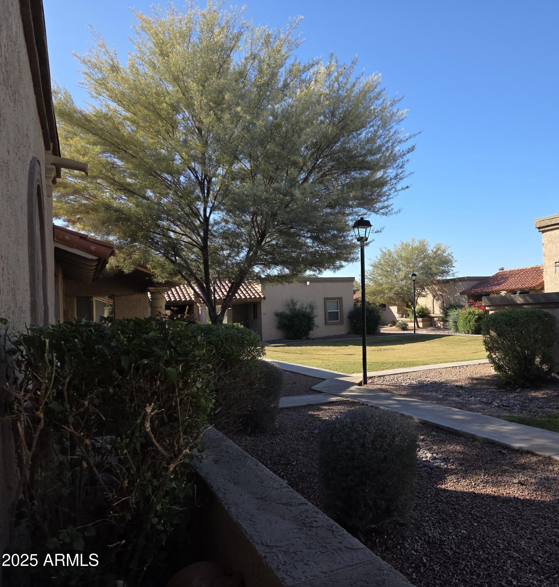 95 North Cooper Road, Unit 66 Chandler, AZ 85225 - Photo 2 of 25 a view of a swimming pool with an outdoor seating