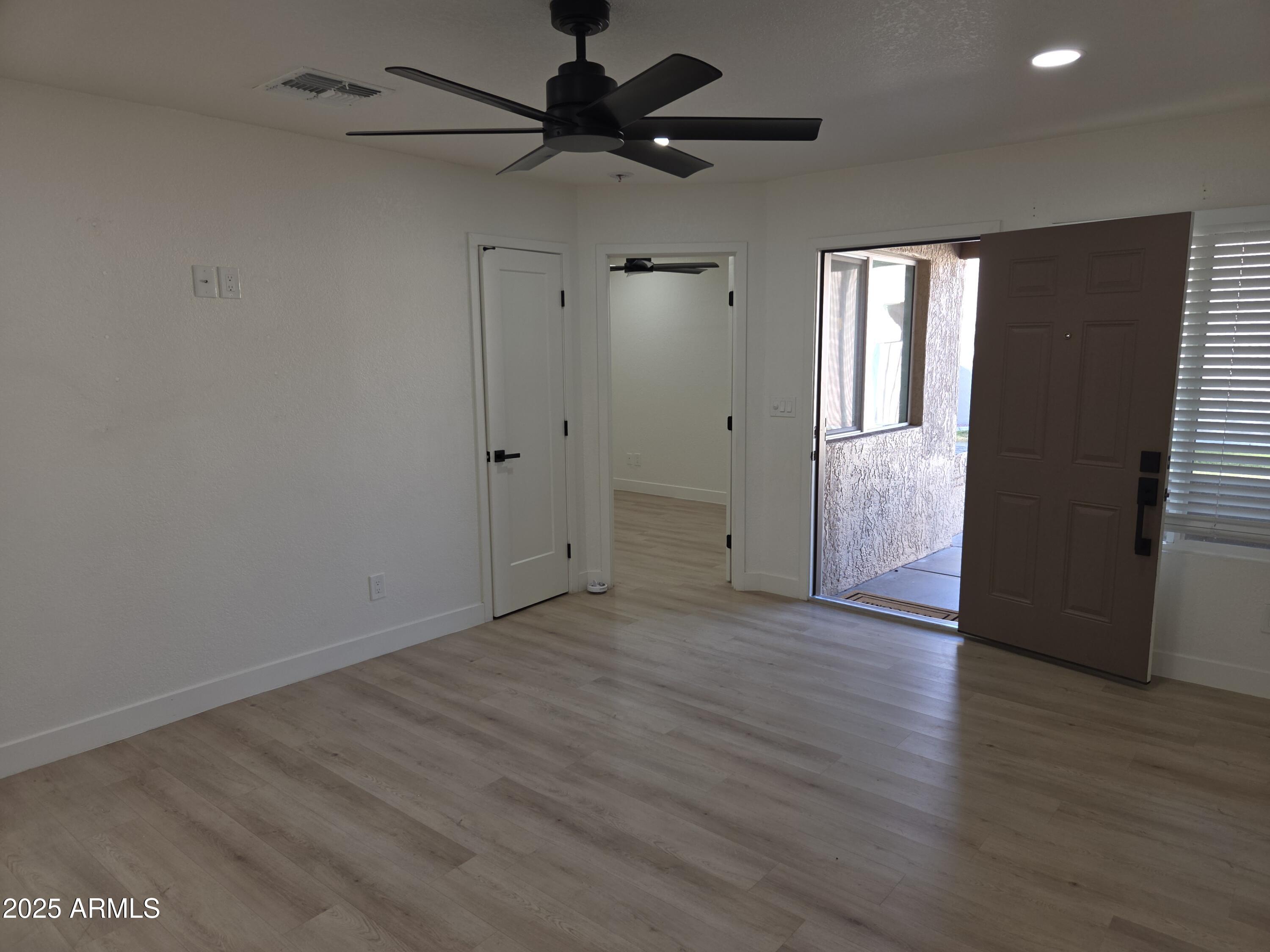 95 North Cooper Road, Unit 66 Chandler, AZ 85225 - Photo 6 of 25 a view of an empty room and wooden floor