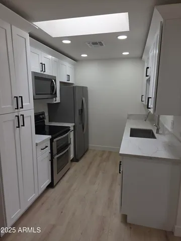 a kitchen with stainless steel appliances a refrigerator and a stove