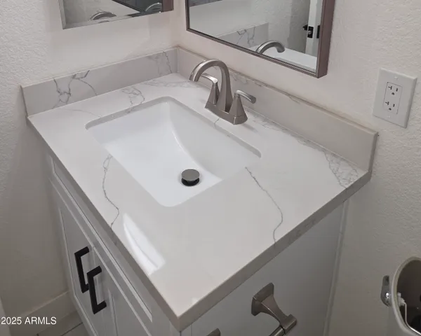 a bathroom with a sink and mirror