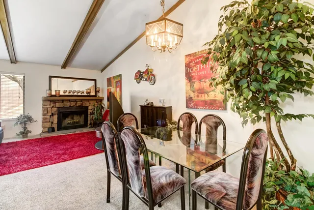 a view of a dining room with furniture and chandelier