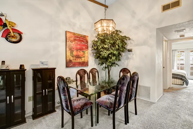 a view of a dining room with furniture and chandelier