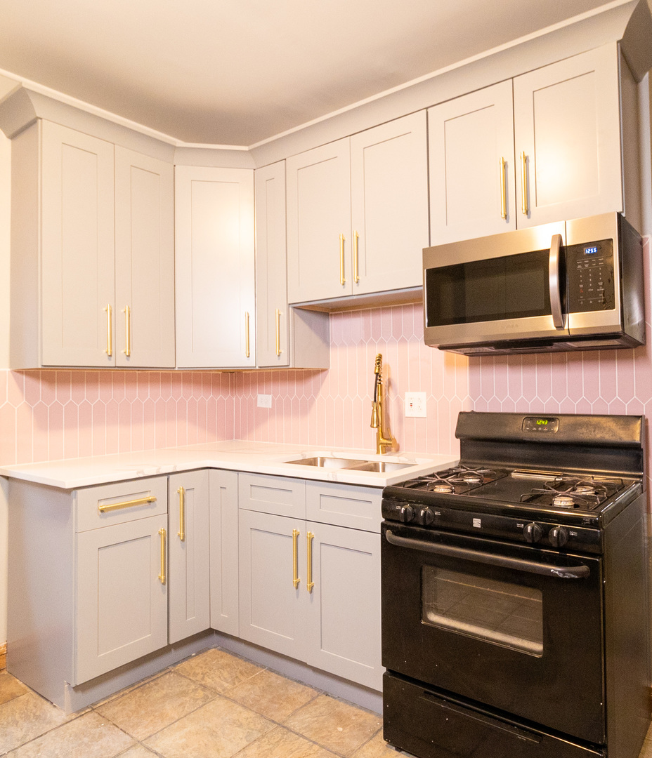 Undisclosed Address Berwyn, IL 60402 - Photo 2 of 8 a kitchen with a stove and a microwave