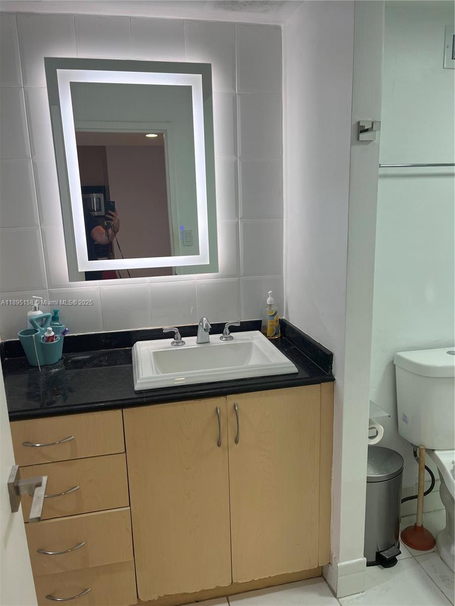 Miami Beach City Center Miami Beach, FL 33139 - Photo 4 of 15 a bathroom with a sink and a toilet