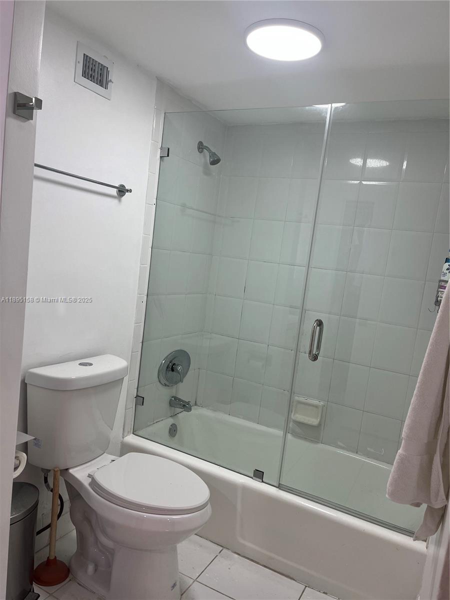 Miami Beach City Center Miami Beach, FL 33139 - Photo 5 of 15 a bathroom with a toilet and a shower