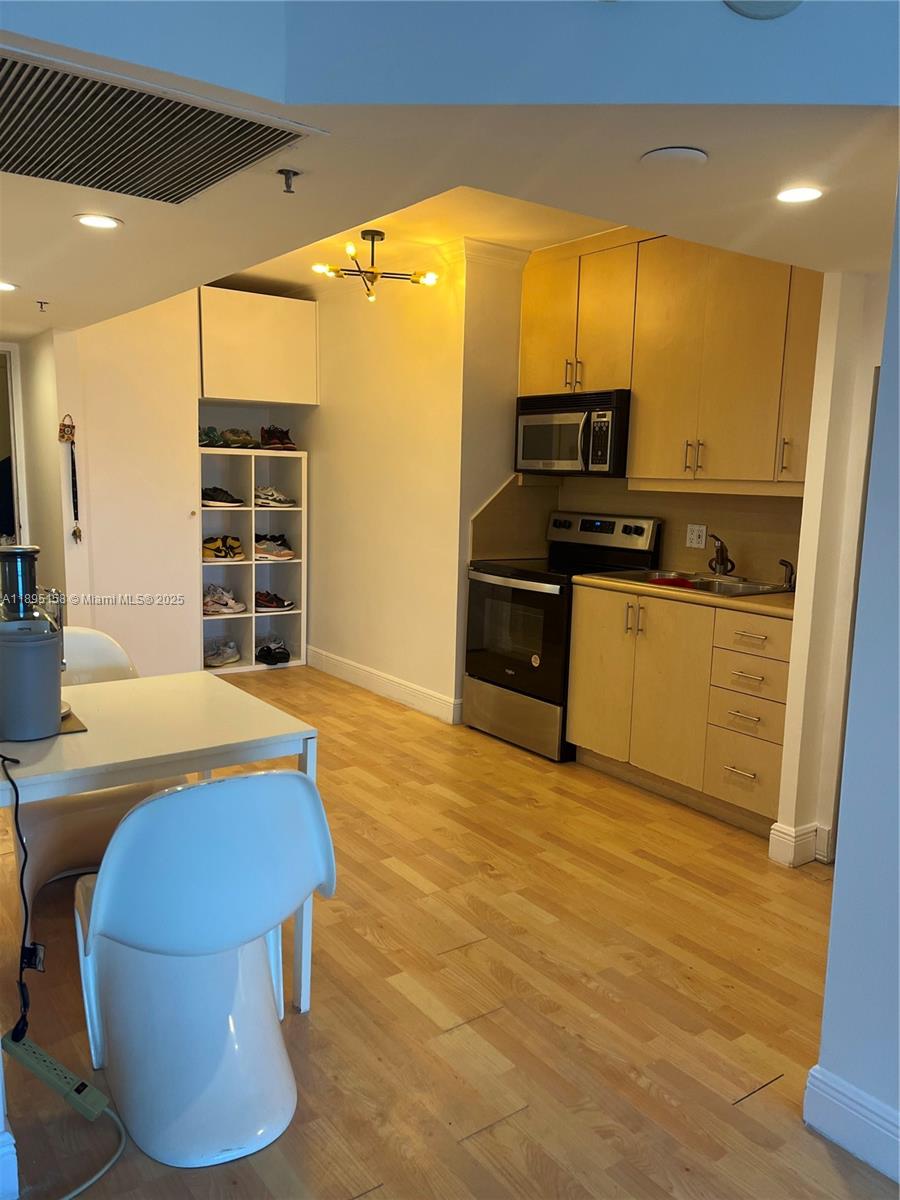 Miami Beach City Center Miami Beach, FL 33139 - Photo 9 of 15 a kitchen with stainless steel appliances kitchen island granite countertop a stove and a refrigerator