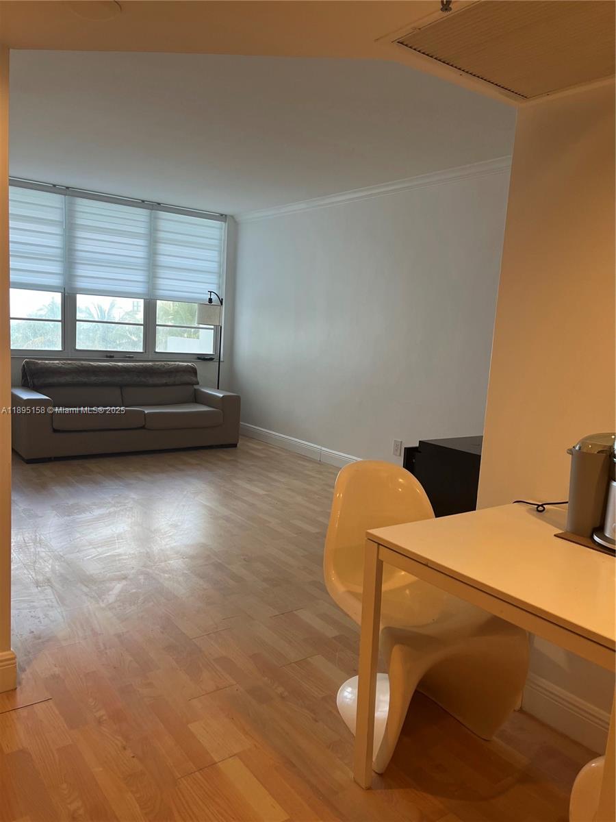 Miami Beach City Center Miami Beach, FL 33139 - Photo 10 of 15 a bedroom with a bed and wooden floor