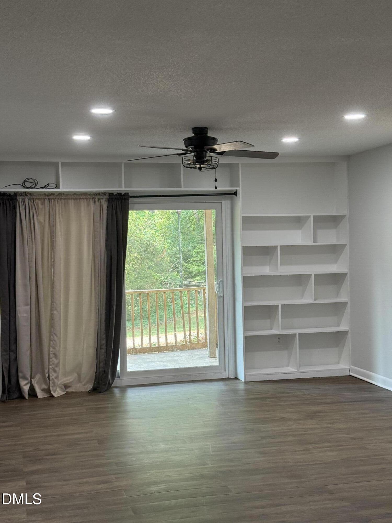 546 Pine Ridge Place Raleigh, NC 27609 - Photo 19 of 28 a view of a room with a large window and wooden floor