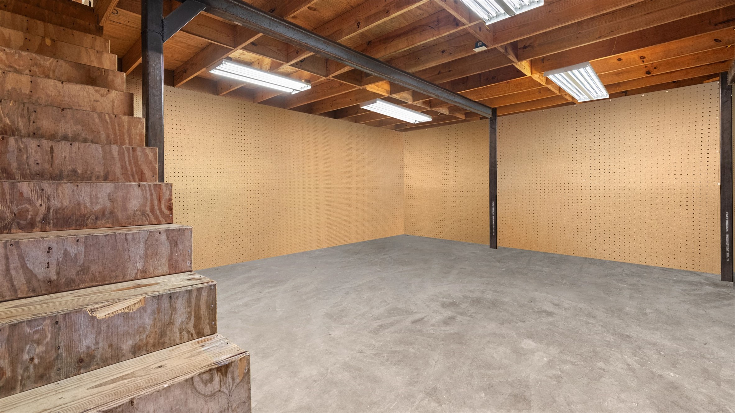 19105 Mueschke Road Tomball, TX 77377 - Photo 15 of 42 Interior view of the two-story garage, providing flexible space for storage, workshop use, equipment, or future operational needs.