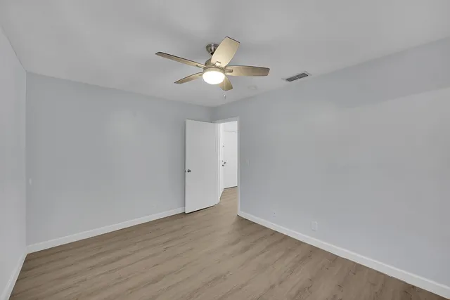 a bathroom with a granite countertop sink mirror vanity and toilet