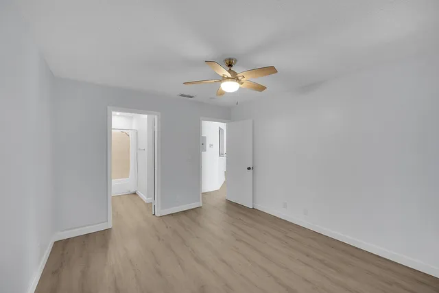a bathroom with a granite countertop sink toilet and a mirror
