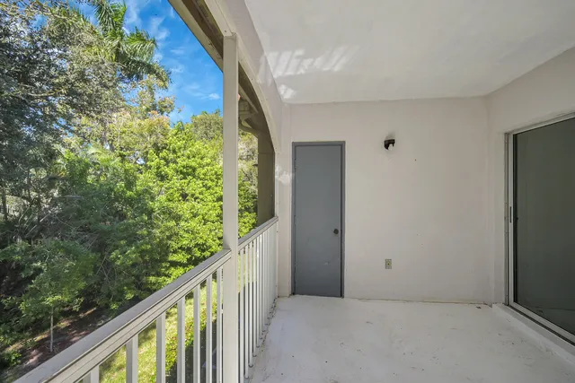 a balcony with trees in front of it