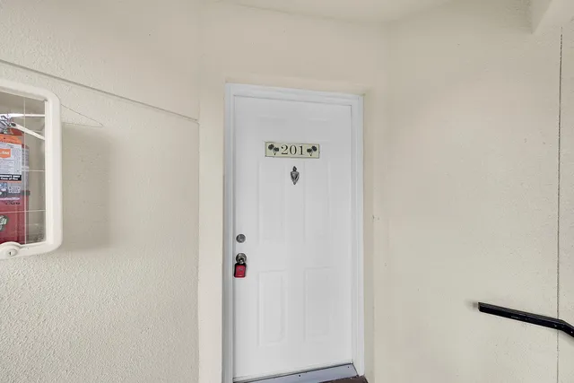 a living room with furniture a fireplace and a chandelier