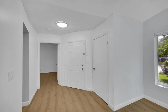 a view of a room with wooden floor and windows