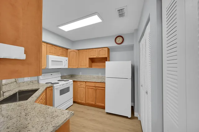 a kitchen with a stove a refrigerator and a sink