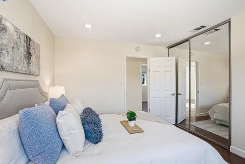 a bedroom with a bed and a couch