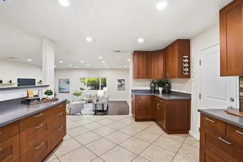 a kitchen with granite countertop a sink and cabinets