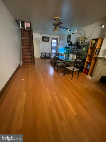 a room with lots of wooden furniture and windows