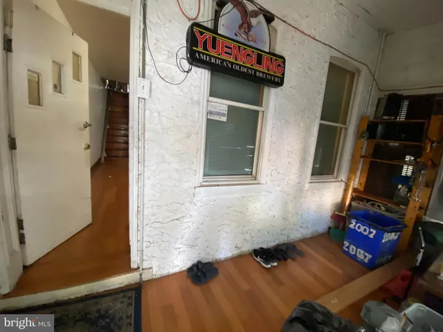 a bathroom with a granite countertop sink a mirror and shower