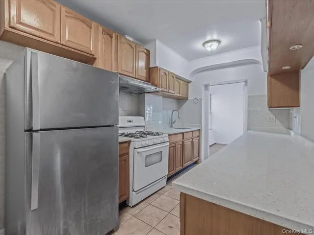 a kitchen with a white cabinets and refrigerator