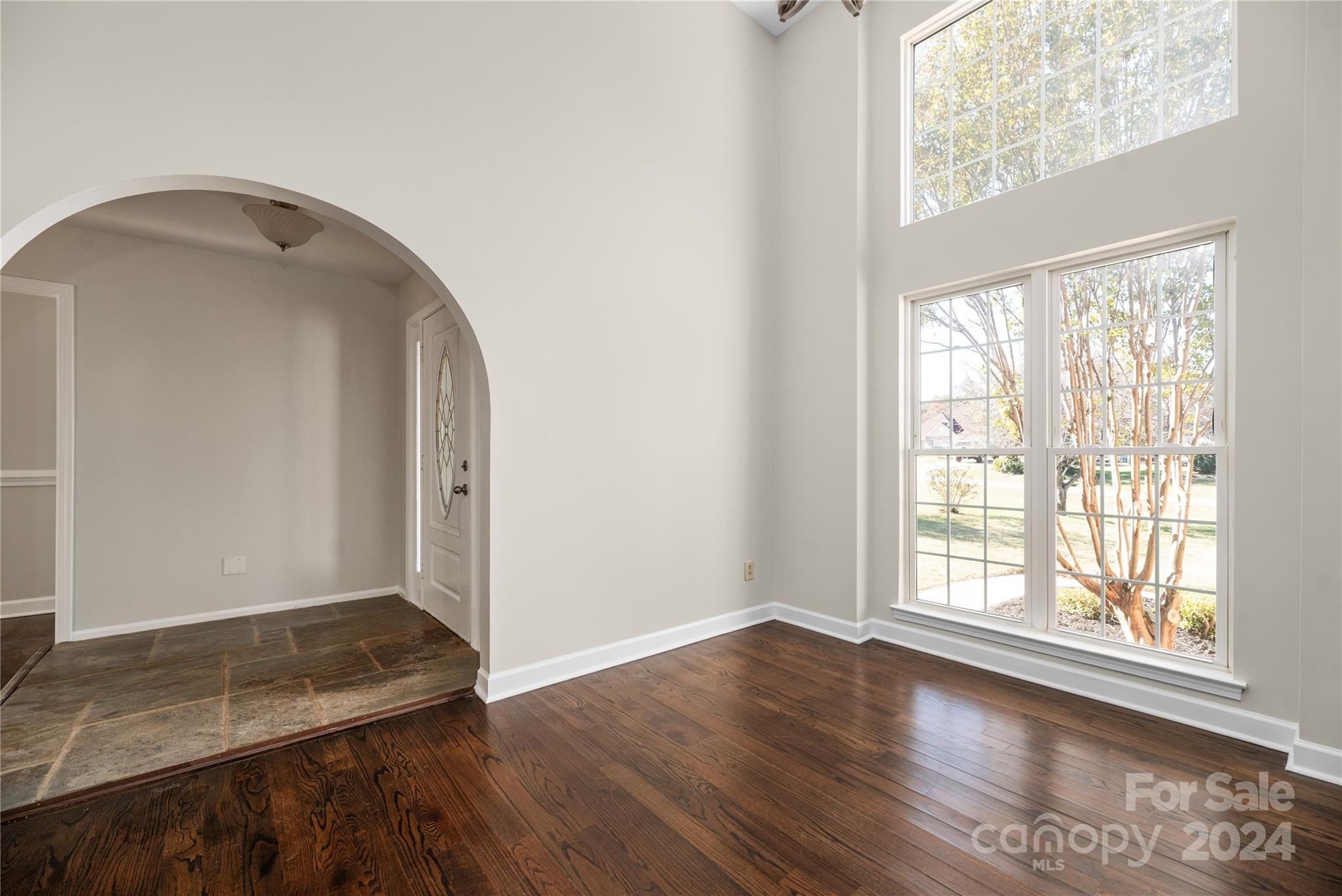 107 Planters Row Road Iron Station, NC 28080 - Photo 11 of 37 an empty room with wooden floor and windows
