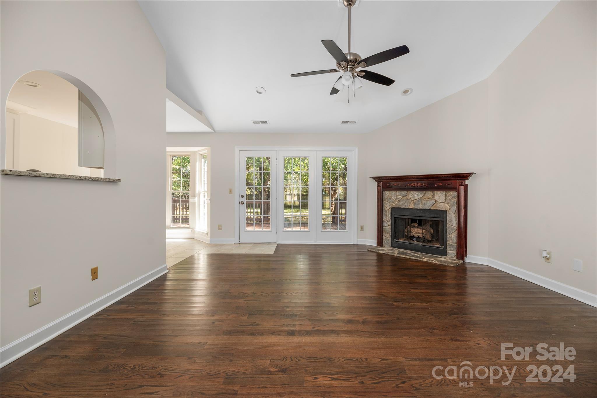 107 Planters Row Road Iron Station, NC 28080 - Photo 13 of 37 an empty room with wooden floor fan and windows