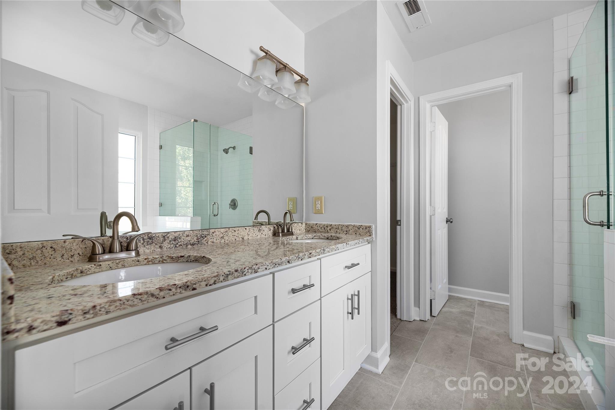 107 Planters Row Road Iron Station, NC 28080 - Photo 28 of 37 a bathroom with a granite countertop sink double and mirror