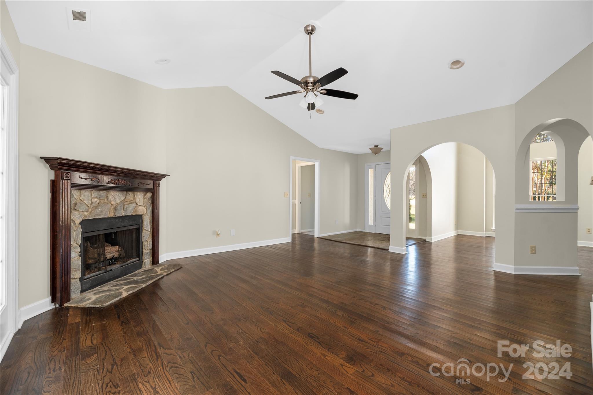 107 Planters Row Road Iron Station, NC 28080 - Photo 6 of 37 a view of empty room with wooden floor and fireplace