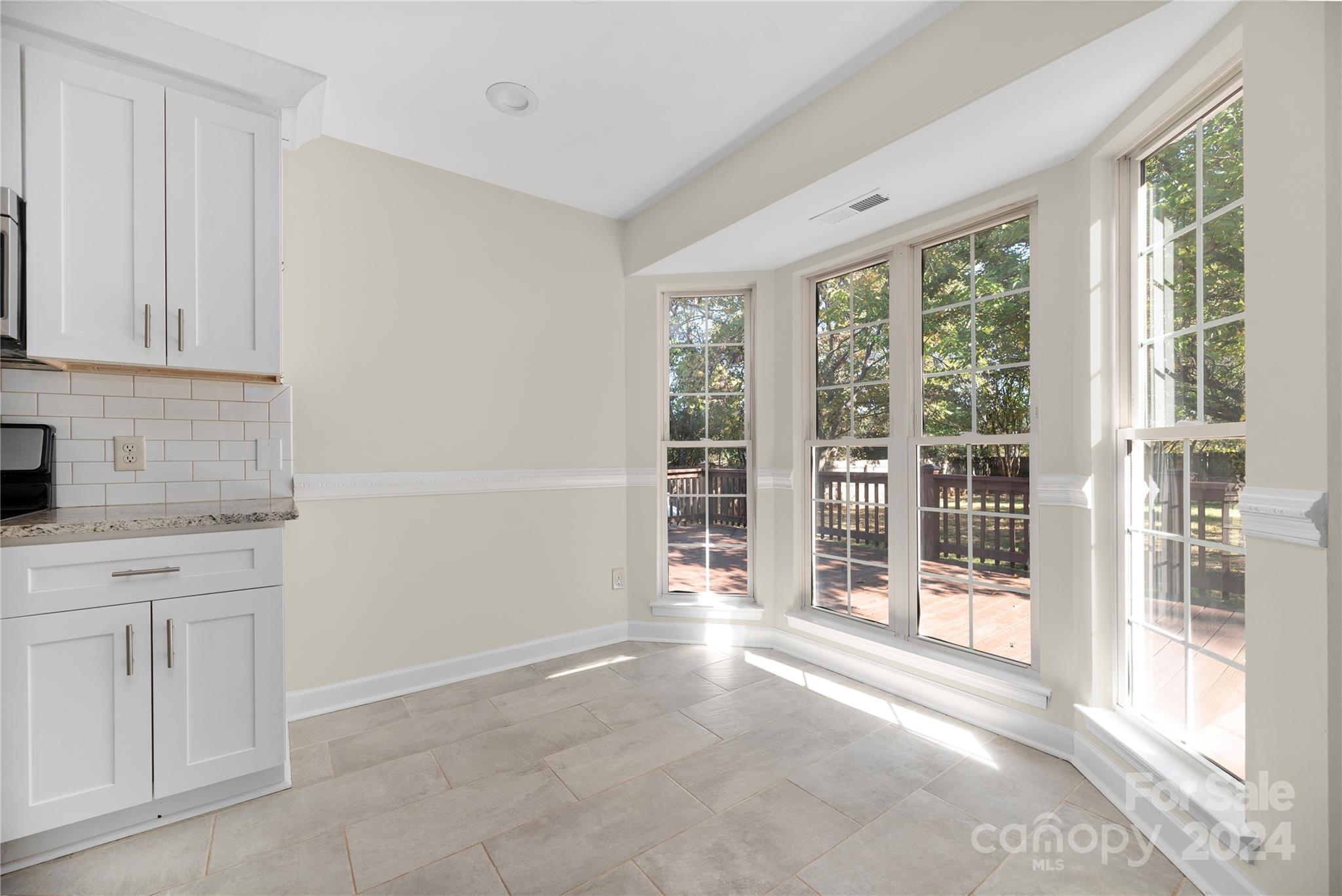 107 Planters Row Road Iron Station, NC 28080 - Photo 10 of 37 a view of empty room with floor to ceiling windows