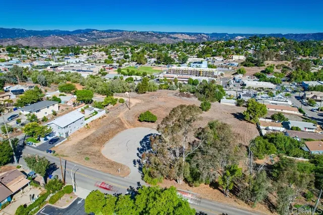 a view of dirt road with a building in the background