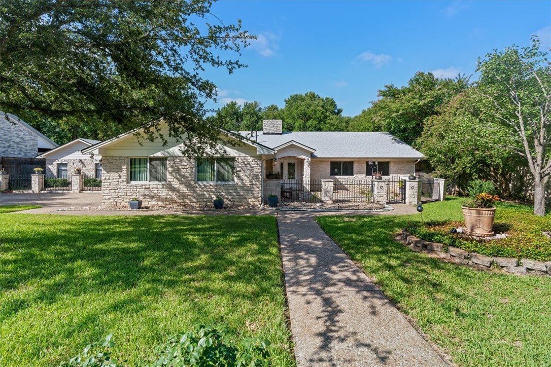 1102 North Ave F Elgin, TX 78621 - Photo 1 of 1 a front view of a house with a garden