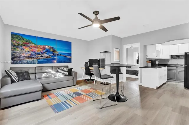 a living room with furniture and kitchen view