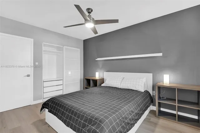 a bedroom with a bed and a ceiling fan
