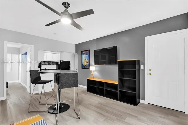 a living room with furniture and a ceiling fan