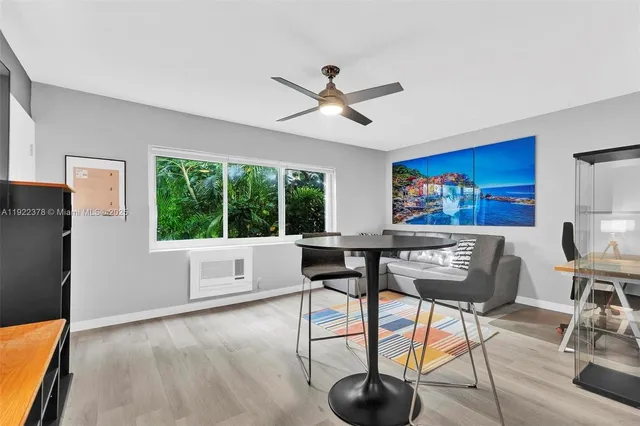 a living room with furniture a rug and a large window