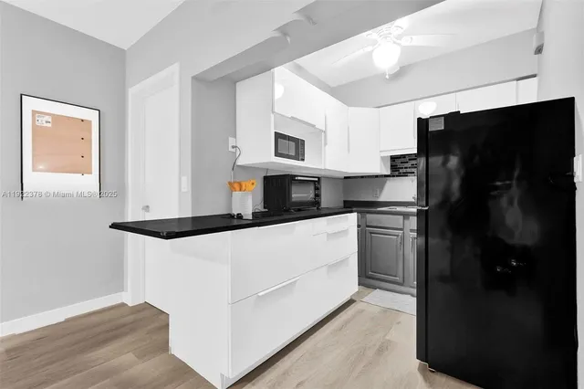 a kitchen with stainless steel appliances a refrigerator stove microwave and cabinets