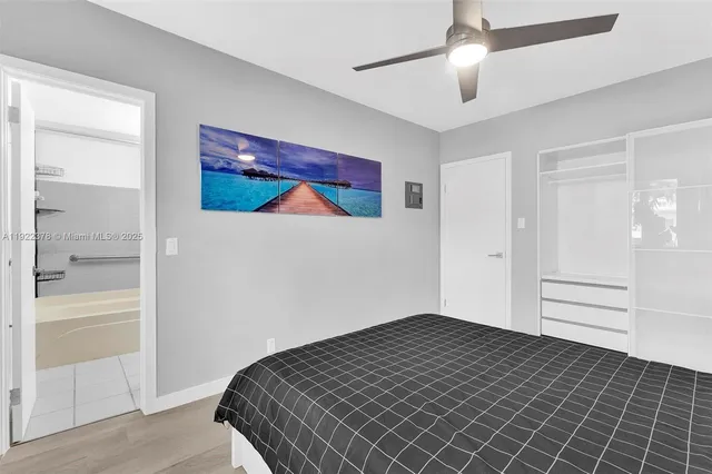 a bedroom with a bed and a painting on the wall