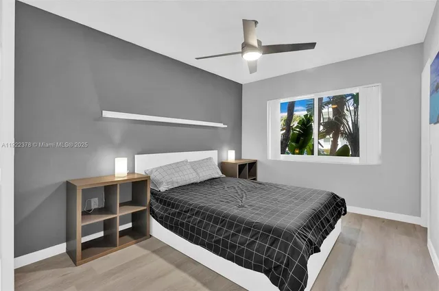 a bedroom with a large bed and a window